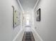 Hallway showcasing tiled floors, neutral paint and decor at 4082 Watson Dr, New Port Richey, FL 34655