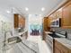 Open kitchen view showcases granite countertops, stainless appliances, and adjacent dining room at 4082 Watson Dr, New Port Richey, FL 34655