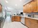 Modern kitchen with granite countertops, stainless appliances, and seamless open layout to living area at 4082 Watson Dr, New Port Richey, FL 34655
