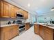 Spacious kitchen with stainless steel appliances and ample wooden cabinet storage at 4082 Watson Dr, New Port Richey, FL 34655