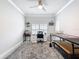 Bright office space featuring a neutral palette, ceiling fan, desk, shelves and a large patterned rug at 4082 Watson Dr, New Port Richey, FL 34655