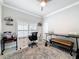 Comfortable home office featuring neutral paint, ceiling fan, large windows, and custom decorations at 4082 Watson Dr, New Port Richey, FL 34655