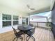 Stylish outdoor patio with ceiling fan and wrought iron table and chairs for comfortable living at 4082 Watson Dr, New Port Richey, FL 34655