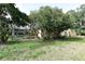 Expansive backyard with screened pool area partially obscured by trees, ensuring privacy at 4269 River Birch Dr, Spring Hill, FL 34607