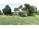 Lush backyard with screened-in pool area and mature trees, a serene outdoor retreat at 4269 River Birch Dr, Spring Hill, FL 34607