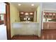 The home features a bar with stone accents, mirrored backsplash and cabinet storage at 4269 River Birch Dr, Spring Hill, FL 34607
