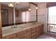 Bathroom with a spacious vanity, dual sinks, and decorative lighting at 4269 River Birch Dr, Spring Hill, FL 34607