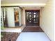 Unique front entrance showcasing an artistic tree-themed double door and adjacent sidelight window at 4269 River Birch Dr, Spring Hill, FL 34607
