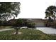 Charming single-story home featuring a well-manicured lawn, mature trees, and a two-car garage at 4269 River Birch Dr, Spring Hill, FL 34607