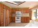Traditional kitchen features wood cabinets, tile backsplash, and white appliances at 4269 River Birch Dr, Spring Hill, FL 34607