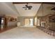 Bright living room features a stone fireplace, ceiling fan, and an open floor plan at 4269 River Birch Dr, Spring Hill, FL 34607
