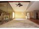 Open living room showcases stone fireplace, ceiling fan, and leads to multiple rooms at 4269 River Birch Dr, Spring Hill, FL 34607
