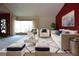 Bright living room featuring white sofas, navy blue accents, and an area rug atop neutral carpet at 4269 River Birch Dr, Spring Hill, FL 34607