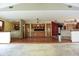 Open-concept living room featuring hardwood floors and a built-in cabinet with glass doors at 4269 River Birch Dr, Spring Hill, FL 34607