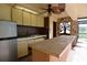 Outdoor kitchen featuring a sink, storage, grill, and large countertops with a decorative stone wall at 4269 River Birch Dr, Spring Hill, FL 34607
