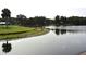 Picturesque waterfront view of pond and dock; a haven for relaxation and nature enthusiasts at 4269 River Birch Dr, Spring Hill, FL 34607