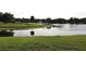Scenic waterfront view overlooking the pond with a dock, enhancing the property's appeal at 4269 River Birch Dr, Spring Hill, FL 34607