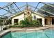 Screened-in pool with stone chimney and landscaping at 4269 River Birch Dr, Spring Hill, FL 34607