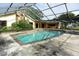 Screened-in pool with patio area and ladders at 4269 River Birch Dr, Spring Hill, FL 34607