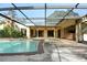 Screened-in pool with patio area and outdoor kitchen at 4269 River Birch Dr, Spring Hill, FL 34607