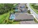 Aerial view of neighborhood homes each with screened in back patios and pools at 4287 Woodland Retreat Blvd, New Port Richey, FL 34655
