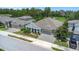 Aerial view of the home displaying a three-car garage, a well-manicured lawn, and mature landscaping at 4287 Woodland Retreat Blvd, New Port Richey, FL 34655