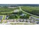 A beautiful aerial view of the home, trees, ponds, and neighborhood at 4287 Woodland Retreat Blvd, New Port Richey, FL 34655