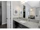 Bathroom with granite counter tops, dual vanity sink and closet with a view of the walk-in closet at 4287 Woodland Retreat Blvd, New Port Richey, FL 34655