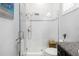 Contemporary bathroom featuring a glass-enclosed shower, neutral tiles, and a stylish wood vanity, enhancing its spa-like atmosphere at 4287 Woodland Retreat Blvd, New Port Richey, FL 34655