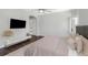 Bright bedroom with dark wood floors, light-colored walls, and a decorative ceiling fan at 4287 Woodland Retreat Blvd, New Port Richey, FL 34655