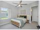 Serene bedroom featuring neutral tones, stylish furnishings, and ample natural light from a window at 4287 Woodland Retreat Blvd, New Port Richey, FL 34655