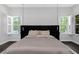Relaxing bedroom with shuttered windows offering views of the pool and green exterior at 4287 Woodland Retreat Blvd, New Port Richey, FL 34655