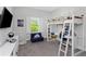 bedroom with built-in loft bed, desk, and ample storage at 4287 Woodland Retreat Blvd, New Port Richey, FL 34655