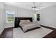 Relaxing bedroom with shuttered windows offering views of the pool and green exterior at 4287 Woodland Retreat Blvd, New Port Richey, FL 34655