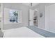 Bright, airy bedroom with neutral decor, featuring a window view and leading to other parts of the house at 4287 Woodland Retreat Blvd, New Port Richey, FL 34655