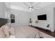 Cozy bedroom with a stylish ceiling fan, wood flooring, and plenty of natural light at 4287 Woodland Retreat Blvd, New Port Richey, FL 34655