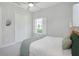 Inviting bedroom with neutral walls, a ceiling fan, and ample natural light creating a relaxing atmosphere at 4287 Woodland Retreat Blvd, New Port Richey, FL 34655