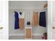 Well-organized closet with clothing, accessories, and a compact storage unit; a functional space at 4287 Woodland Retreat Blvd, New Port Richey, FL 34655