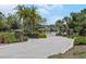 Community entrance featuring a brick and stone pillar entrance and lush landscaping along the street at 4287 Woodland Retreat Blvd, New Port Richey, FL 34655