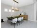 Contemporary dining room featuring modern lighting fixture and a sleek table set for an elegant gathering at 4287 Woodland Retreat Blvd, New Port Richey, FL 34655