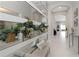 Bright hallway features decorative wall mirrors and arched doorway at 4287 Woodland Retreat Blvd, New Port Richey, FL 34655