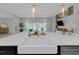 Spacious kitchen with marble countertop island, stainless steel sink, and pendant lighting at 4287 Woodland Retreat Blvd, New Port Richey, FL 34655