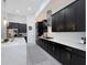 Well-lit kitchen featuring a stylish rug, white marble counters, and dark, modern cabinetry at 4287 Woodland Retreat Blvd, New Port Richey, FL 34655