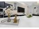 Bright kitchen featuring white marble counters, stainless steel appliances and stylish dark cabinetry at 4287 Woodland Retreat Blvd, New Port Richey, FL 34655
