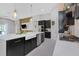 Kitchen featuring large island, stainless steel appliances, stylish hanging lights and a farmhouse sink at 4287 Woodland Retreat Blvd, New Port Richey, FL 34655