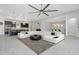 Spacious open-concept living area with modern decor and seamless access to the kitchen and dining spaces at 4287 Woodland Retreat Blvd, New Port Richey, FL 34655