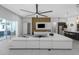 Bright living area featuring tile floors, a ceiling fan, open floorplan, and access to kitchen at 4287 Woodland Retreat Blvd, New Port Richey, FL 34655