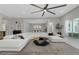 Open-concept living room with oversized sofa, decorative rug, and archway to dining room at 4287 Woodland Retreat Blvd, New Port Richey, FL 34655