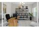 Home office with wood desk, modern shelving, and bright window at 4287 Woodland Retreat Blvd, New Port Richey, FL 34655