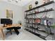Office with modern shelving, wood desk, and rolling desk chair at 4287 Woodland Retreat Blvd, New Port Richey, FL 34655